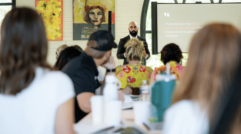 Ayman Al-Abdullah leading a live workshop for attendees seated at tables